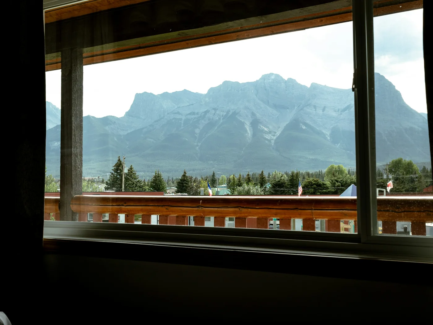 Canadian Rockies seen through a real hotel room window in Canmore, Alberta